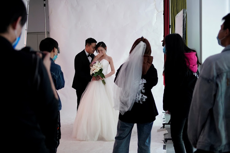 Peng Jing, 24, and Yao Bin, 28, pose for their wedding photography shoot after the lockdown was lifted in Wuhan, capital of Hubei province and China's epicentre of the novel coronavirus disease (COVID-19) outbreak, April 15, 2020.