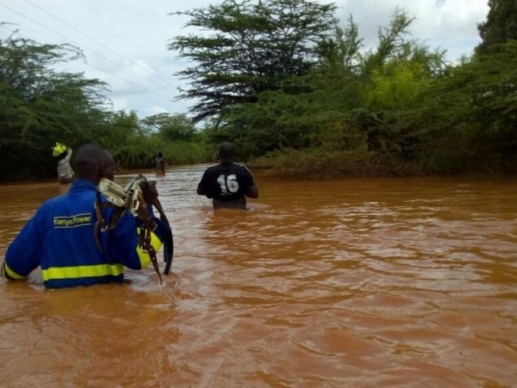 Residents walking in flood water in Boji,15 KMs from Masalani town,Garissa