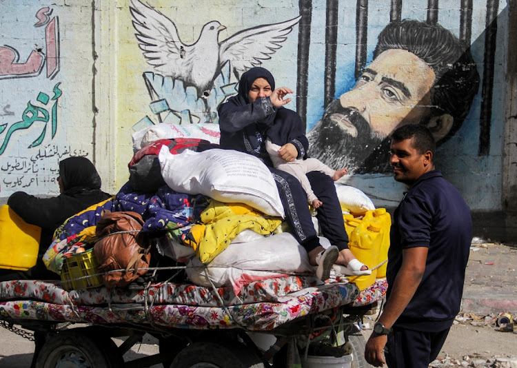 A displaced Palestinian woman, who fled Jabalia after the Israeli military called on residents to evacuate, sits on top of her belongings in an animal-drawn cart during the ongoing conflict between Israel and Hamas in Gaza City on May 12 2024. Israel has defended it military offensive. File photo.