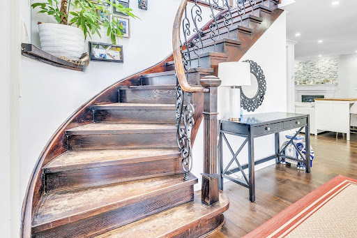 curved wooden staircase with ornate railing - Buy this luxury house in Toronto, 4 bedrooms