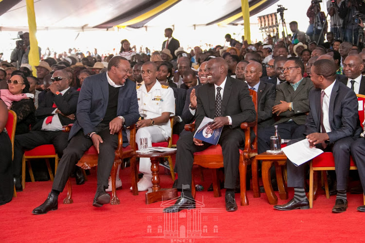 President Uhuru Kenyatta with Deputy President William Ruto at the late De' Mathew's funeral service in Murang'a.