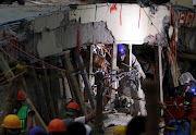 Rescue workers search through the rubble for students at Enrique Rebsamen school after an earthquake in Mexico City, Mexico, September 20, 2017. 