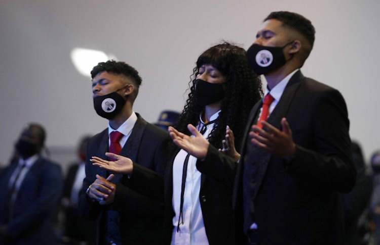 Nicolette Kinnear, the widow of murdered detective Lt-Col Charl Kinnear, with the couple's sons, Casleigh and Carlisle, at her husband's funeral on October 3 2020.