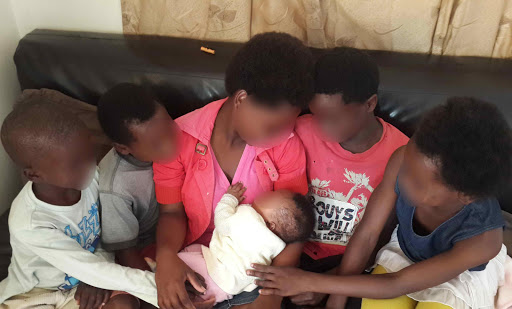 MAKING NEW AND HAPPIER MEMORIES: The five younger Gada siblings with baby Buhle, their 16-year-old sister Asanda’s daughter. The family live together in a cluster foster home, near their birth home (faces have been blurred to protect their identities) Pictures: SIYA BOYA