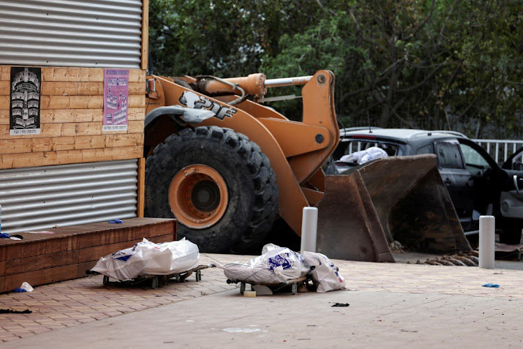 The bodies of two people on stretchers in Sderot, southern Israel, October 8 2023. Picture: RONEN ZVULUN/REUTERS