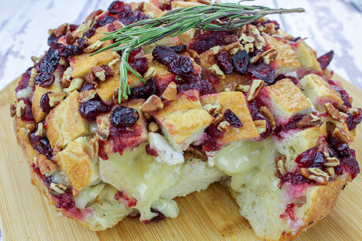 Cranberry Brie Pull-Apart Bread with Brie oozing out of the bread.