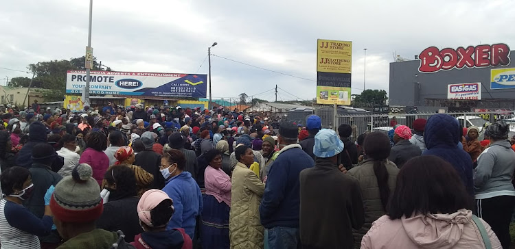 Crowds of people waited for food parcel vouchers in Duncan Village.