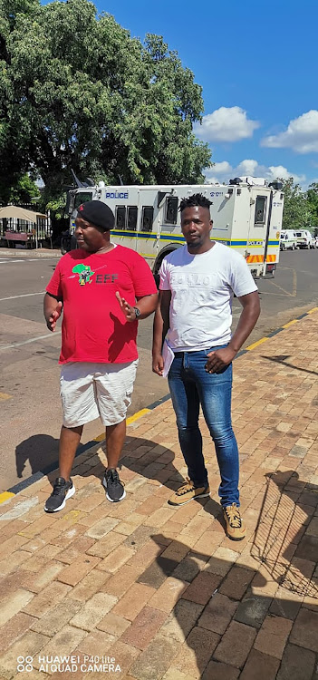 Veneruru Kavari who was allegedly assaulted and had dogs set on him by his boss at his farm in Groblersdal, with an EFF supporter outside court