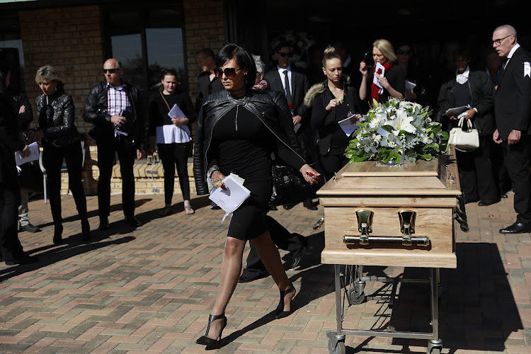 Marc Batchelor's fiancee Chere Gray walks ahead of his casket.