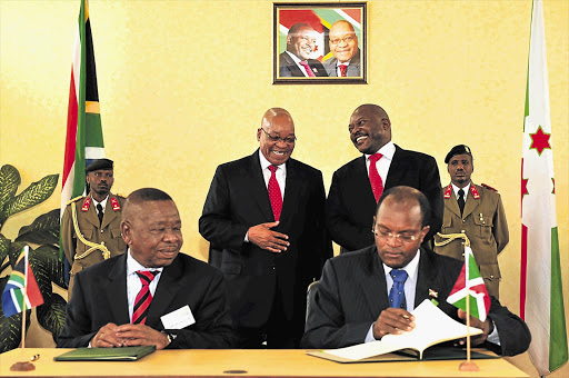 President Jacob Zuma and Burundi President Pierre Nkurunziza witness the signing of agreements by their higher education ministers, Blade Nzimande, left, and Julien Nimubona, during Zuma's state visit to Burundi yesterday. Zuma said their talks and agreements signed were an indication of a collective determination to take relations between the two countries to higher levels. He said they reflected developments relating to the East African region and global and multilateral matters of interest and concern. The presidents exchanged views on Africa's latest political developments. Zuma reiterated South Africa's commitment and support for Burundi's work under the auspices of the African Union peacekeeping mission Picture: DIRCO