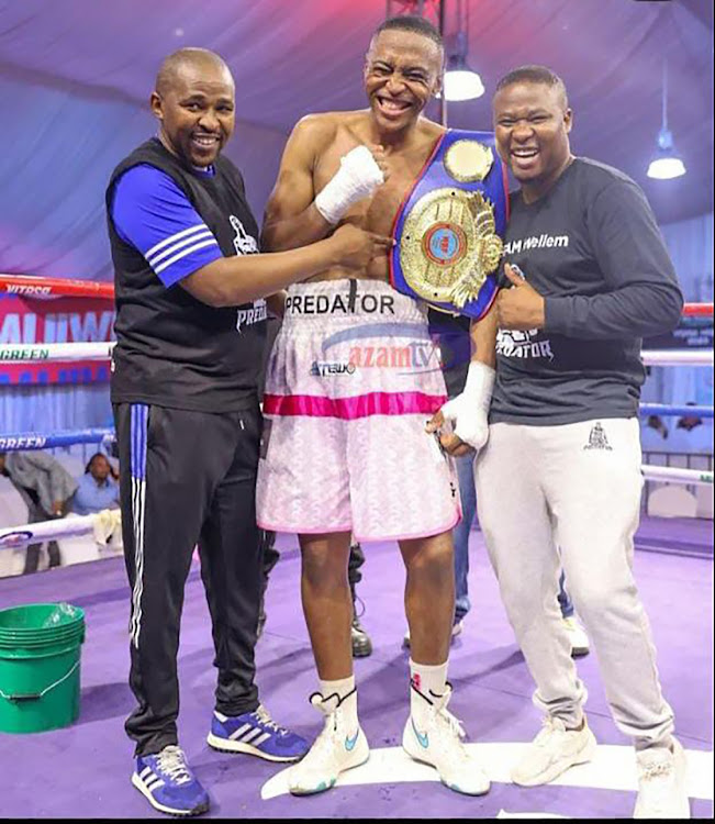 SA super middleweight hchampion Asemahle Wellem celebrates his win with trainer Phumzile Matyhila and manager Siya Zingelwa.