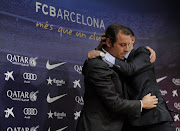 Barcelona's football club president Sandro Rosell (L) is hugged by club vice president Josep Maria Bartomeu during a press conference to announce his resignation following an extraordinary board meeting at the club offices in Barcelona on January 23, 2014. Rosell resigned amid a legal wrangle over the signing of Brazilian star Neymar and leaves the Barcelona football club in the hands of vice president Josep Maria Bartomeu until the end of his mandate in 2016. AFP