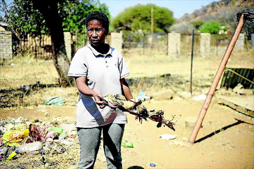 GRIM: Connie Radibe holds clothes her child wore when she was burnt PHOTO Thulani Mbele