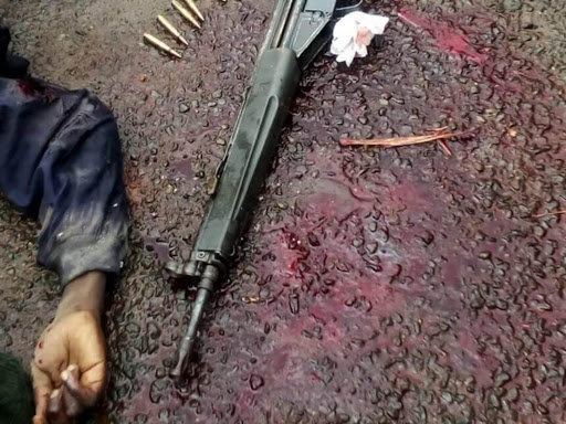 The body of one of the suspects lies next to a G3 rifle and rounds of ammunition recovered from him after police shot and killed two of the three suspected robbers near Toyota Kenya on Kisumu-Busia road on Saturday June 17. /FAITH MATETE