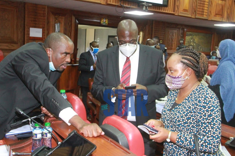 Kirinyaga Governor Ann Waiguru consults with her Lawyers Kamotho Waiganjo and Paul Nyamodi during a short break at the Senate on Tuesday, June 23, 2020.