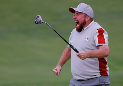 Team Europe's Shane Lowry celebrates after holing his putt on the 18th green to win the match during the Four-balls.