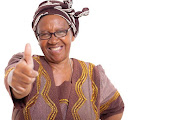 Mature African woman with happy smile giving thumbs up on white background Picture:  Stock image