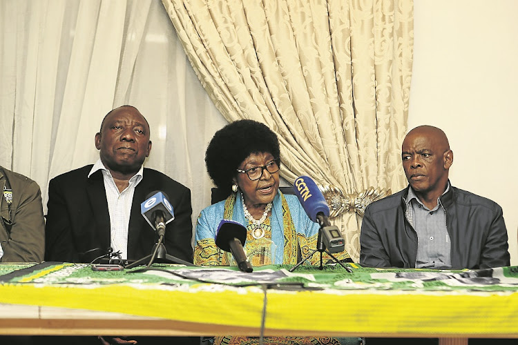 ANC stalwart Winnie Madikizela-Mandela is flanked by the party president Cyril Ramaphosa and secretary-general Ace Magashule at her home in Soweto.