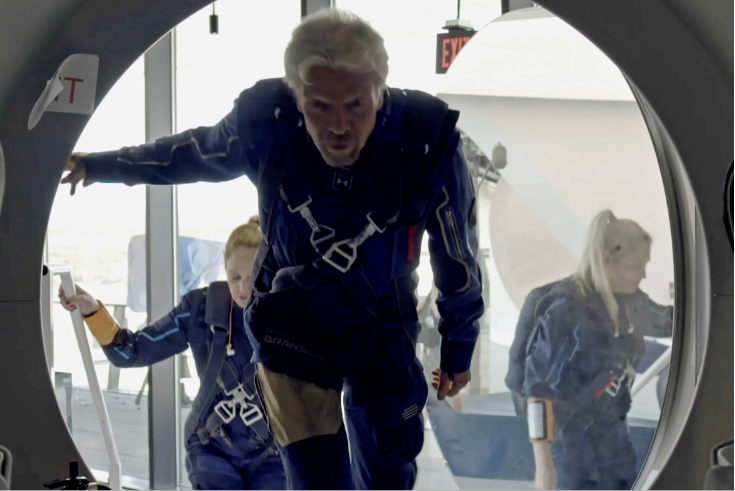 Richard Branson and Virgin Galactic crew members enter the company's passenger rocket plane, the VSS Unity, in a still image from undated handout video taken at Spaceport America near Truth or Consequences, New Mexico, US.