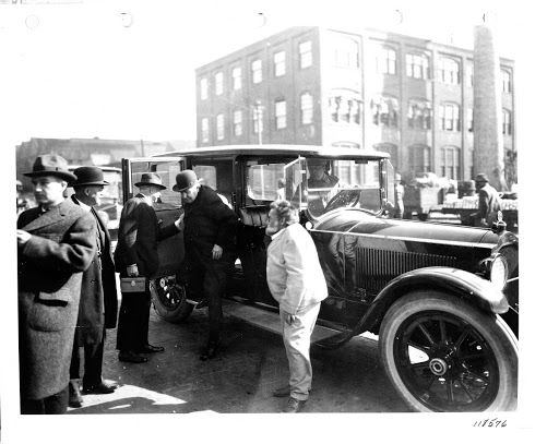 Thomas Edison getting out of a car as Charles Steinmetz looks on near the front of the car at GE's Schenectady Works.
