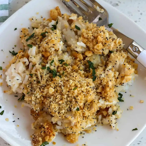 A quick and easy classic Poppy Seed Chicken Casserole Recipe with white rice, homemade cream of chicken soup, already cooked rotisserie chicken breasts, poppy seeds, and a buttery cracker crumb topping