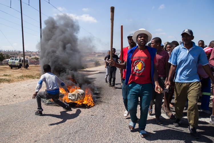 About 100 protesters marched through town. Some erected burning barricades.