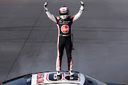 Christopher Bell celebrates after winning the NASCAR Cup Series Shriners Children's 500 at Phoenix Raceway on March 10 2024 in Avondale, Arizona.