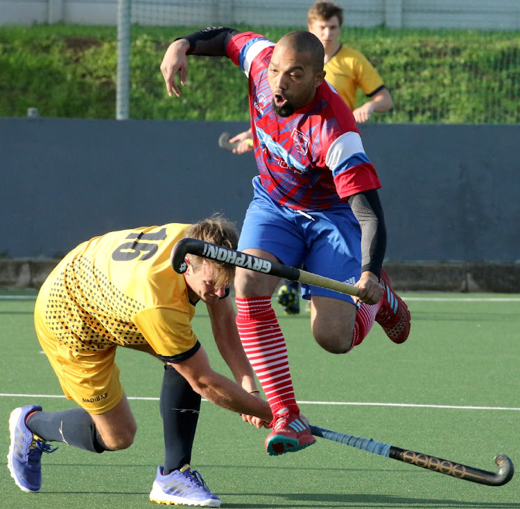 NMU's Edward Gibbons clears as St Peters' Darren Kimfley takes evasive action at the KC March Astro in Gelvandale on Sunday