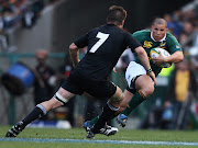 Springbok try scorer Ricky Januarie is closed down by All Black captain Richie McCaw during the 2008 Tri Nations.