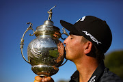 Christiaan Bezuidenhout with the SA Open Championship title he won at the Gary Player Country Club in Sun City last year. He returns this year to defend it.