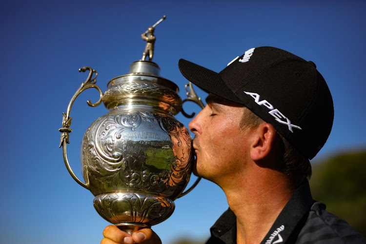 Christiaan Bezuidenhout with the SA Open Championship title he won at the Gary Player Country Club in Sun City last year. He returns this year to defend it.