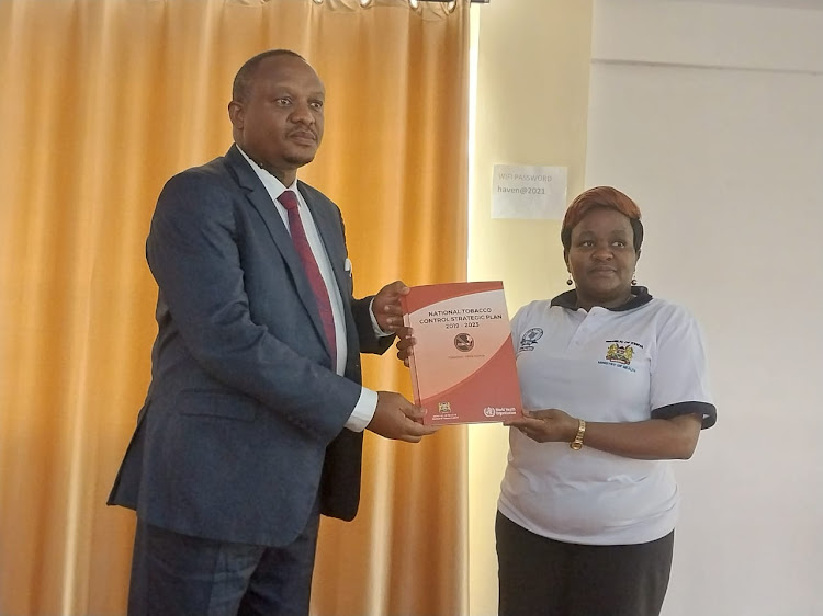 Machakos Health Chief Officer Lucas Muove with National Tobacco Control Board Technical Committee chairperson Lillian Mbevi during a workshop in Machakos on Wednesday, May 25.