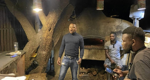 Singing Baker Mteto Maphoyi thrills patrons at the pizzeria where he works.