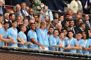 Manchester City forward Erling Haaland lifts the FA Cup trophy after his team's victory over Manchester United in the Emirates FA Cup final at Wembley Stadium.