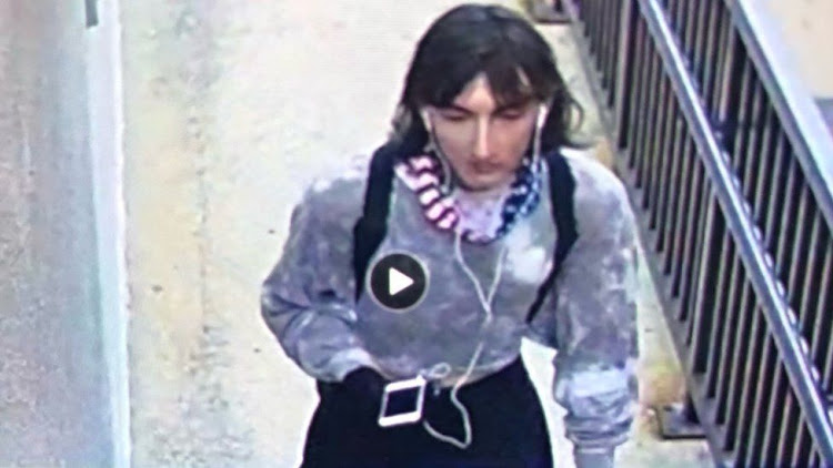 The suspect escaping disguised as a woman.