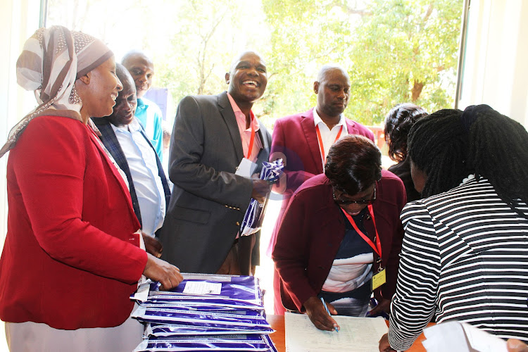 Kitui Central Sub County Education Director, Mary Shallo, with secondary schools principals during distribution of KCSE exam papers at the county commissioner’s office on November 6, 2023.