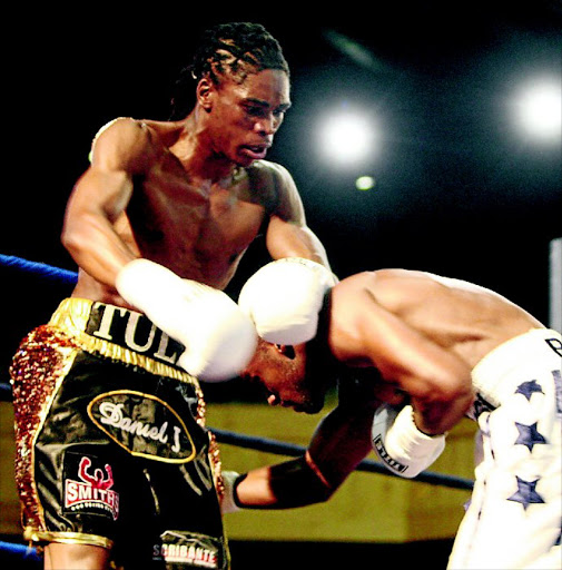 RISING: Thulani Mbenge, left, has raced up boxing ratings after just five pro bouts. In this action Mbenge subdues Xolani Ngidi in Benoni in October last year. Photo: Antonio Muchave