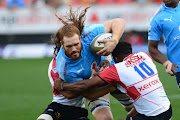 Jannes Kirsten of the Blue Bulls tackled by Ashlon Davids of the Lions during the Currie Cup match between Xerox Golden Lions and Vodacom Blue Bulls at Emirates Airline Park on September 16, 2017 in Johannesburg, South Africa.