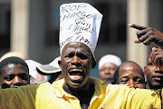 A Malema supporter outside the High Court in Johannesburg, where Malema was recently found guilty of hate speech. He was also ordered to pay about R400 000 to Afriforum, one of the complainants. Picture: ALON SKUY