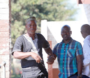 Alleged poaching 'kingpin', Dumisani Gwala, confronts a TimesLIVE photographer after appearing in the Ngwelezane Magistrates Court in Zululand on Friday. With him is co-accused Aubrey Dlamini.
