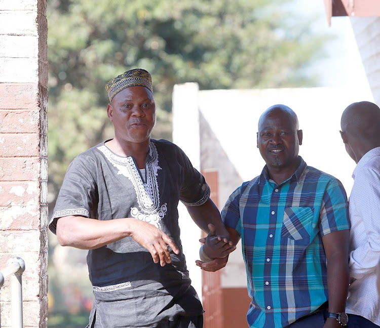 Alleged poaching 'kingpin', Dumisani Gwala, confronts a TimesLIVE photographer after appearing in the Ngwelezane Magistrates Court in Zululand on Friday. With him is co-accused Aubrey Dlamini.