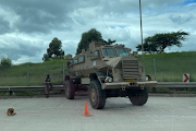 SA National Defence Force soldiers near Mariannhill Toll Plaza in Durban keeping watch with police officers on Friday.