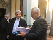 Retired Hawks head Johan Booysen, right, with attorney Carl van der Merwe outside the Durban high court.