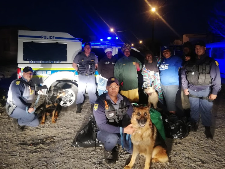 Members of the Police's K9 Unit paid a visit to the family who lost their home in a fire in Walmer to hand over clothes, blankets and food to the family.