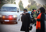 Mourners carried roses in honour of Zindzi Mandela as her coffin arrived at the Fourways Memorial Park where she was being laid to rest on Friday July 17 2020. 