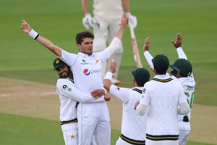 Pakistan's Shaheen Afridi celebrates with teammates after taking the wicket of England's Rory Burns in a past match