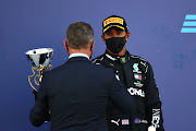 Dmitry Kozak, deputy chief of staff of the presidential executive office, presents Lewis Hamilton of Great Britain and Mercedes GP with his third place trophy at the F1 Grand Prix of Russia at Sochi Autodrom on September 27 2020.