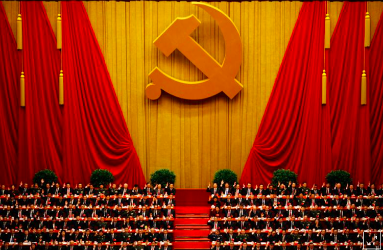 A general view shows delegates raising their hands as they take a vote at a past session of the national congress of the Communist Party of China at the Great Hall of the People in Beijing.