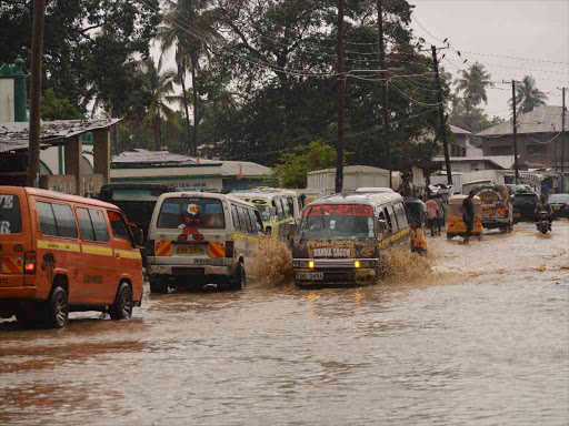 Motorist wade through a flood road at Bamburi in Mombasa yesterday.Photo John Chesoli