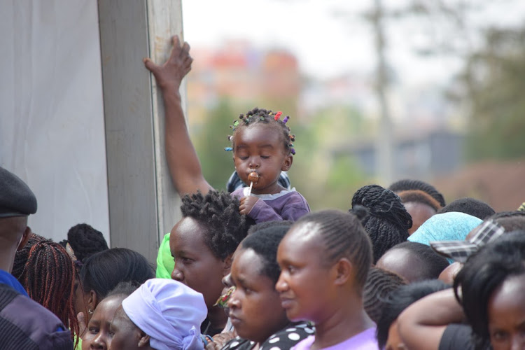 A little girl enjoying her sweet during the launching of food support for vulnerable households in Nairobi on Saturday, November 5, 2022.